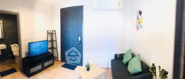 Modern living room with sleek furniture and wall art, featuring a cozy ambiance.