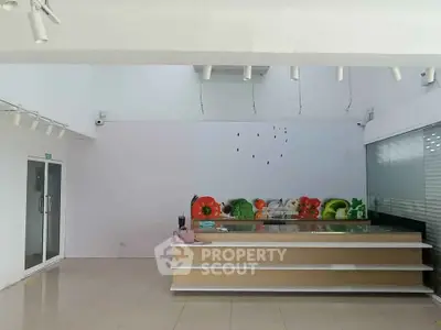 Spacious modern kitchen with sleek design and ample natural light, perfect for culinary enthusiasts.