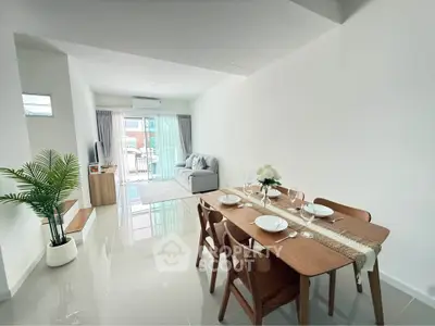 Modern open-plan living and dining area with elegant decor and natural light.
