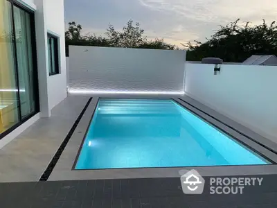 Modern private pool with sleek design and ambient lighting in a luxury home setting.