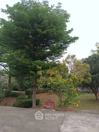 Serene garden with lush trees and vibrant flowers, perfect for relaxation.