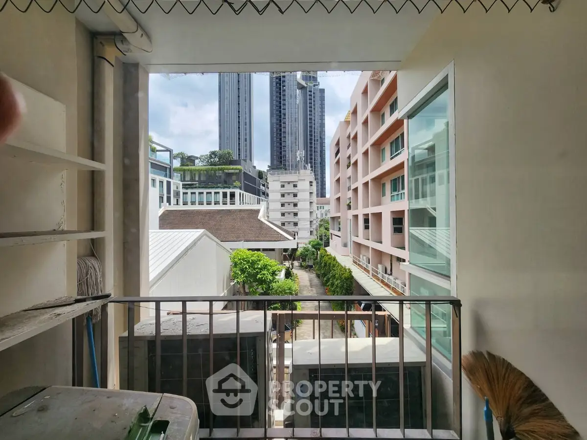 Charming urban balcony view with cityscape and modern buildings.