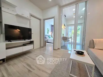 Modern living room with sleek design and open view to dining area and bedroom.
