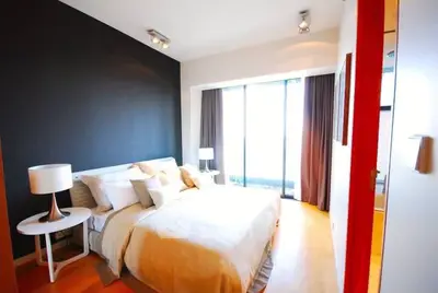 Elegant bedroom with modern design and large window for natural light.