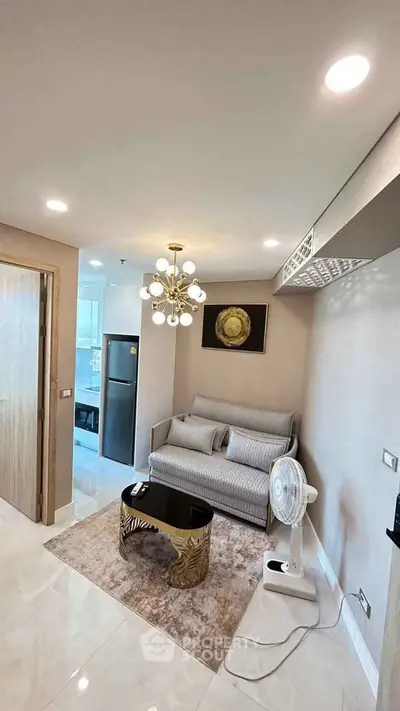 Modern living room with stylish decor and elegant lighting in a cozy apartment setting.