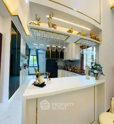 Luxurious modern kitchen with elegant decor and open layout, featuring sleek cabinetry and stylish lighting.