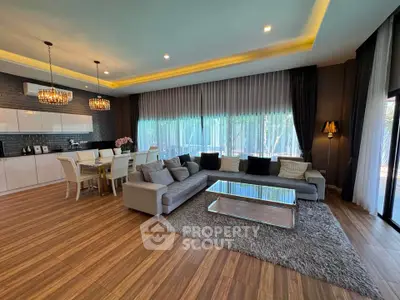 Luxurious open-plan living room with elegant dining area and modern decor.