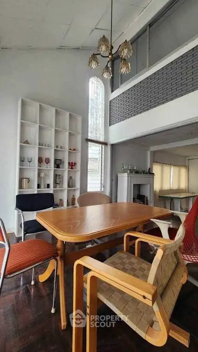 Chic dining area with modern furniture and high ceiling, perfect for stylish gatherings.