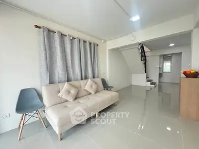 Spacious modern living room with sleek tile flooring and stylish furniture in a contemporary home.