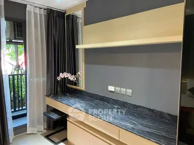 Modern bedroom with sleek black marble desk and large window overlooking greenery.