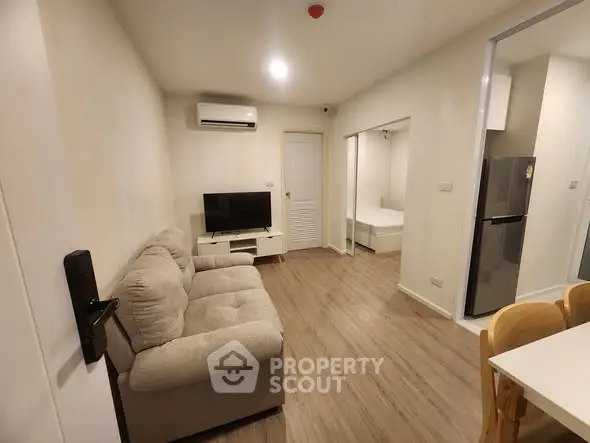 Modern apartment living room with cozy sofa and sleek kitchen area