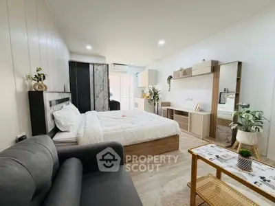 Modern studio apartment with cozy bedroom and stylish living area, featuring elegant decor and ample natural light.