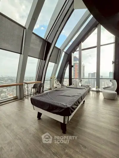 Stunning modern room with panoramic city views and sleek furnishings in a high-rise building.