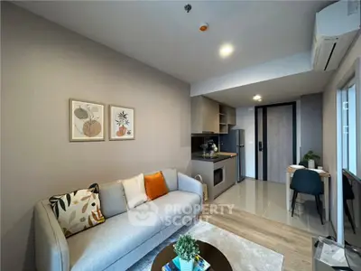 Modern living room with stylish decor and open kitchen layout in a cozy apartment.