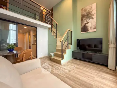 Modern duplex living room with stylish decor and open staircase