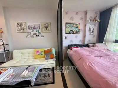 Charming bedroom with cozy seating area and floral decor, perfect for relaxation and comfort.