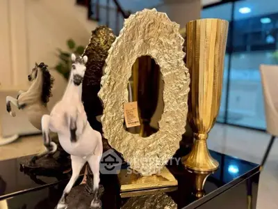 Luxurious interior decor with elegant gold sculptures and modern design elements.