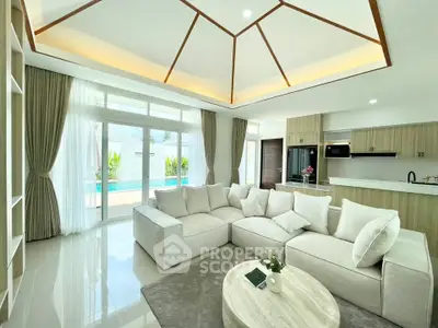 Luxurious open-plan living room with pool view and modern kitchen