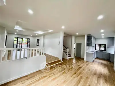 Spacious open-plan living area with modern kitchen and wooden flooring