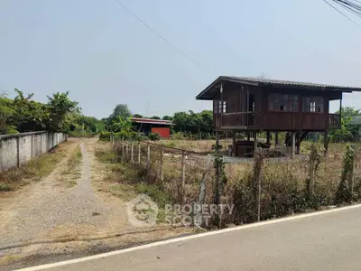 Charming rustic wooden house on stilts with spacious land and rural surroundings.
