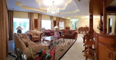 Luxurious living room with elegant furniture and chandelier, perfect for entertaining guests.