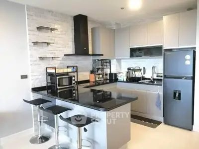 Modern kitchen with sleek design, featuring an open layout and contemporary appliances.