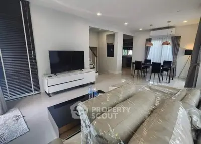 Modern living room with sleek furniture and open dining area in contemporary home