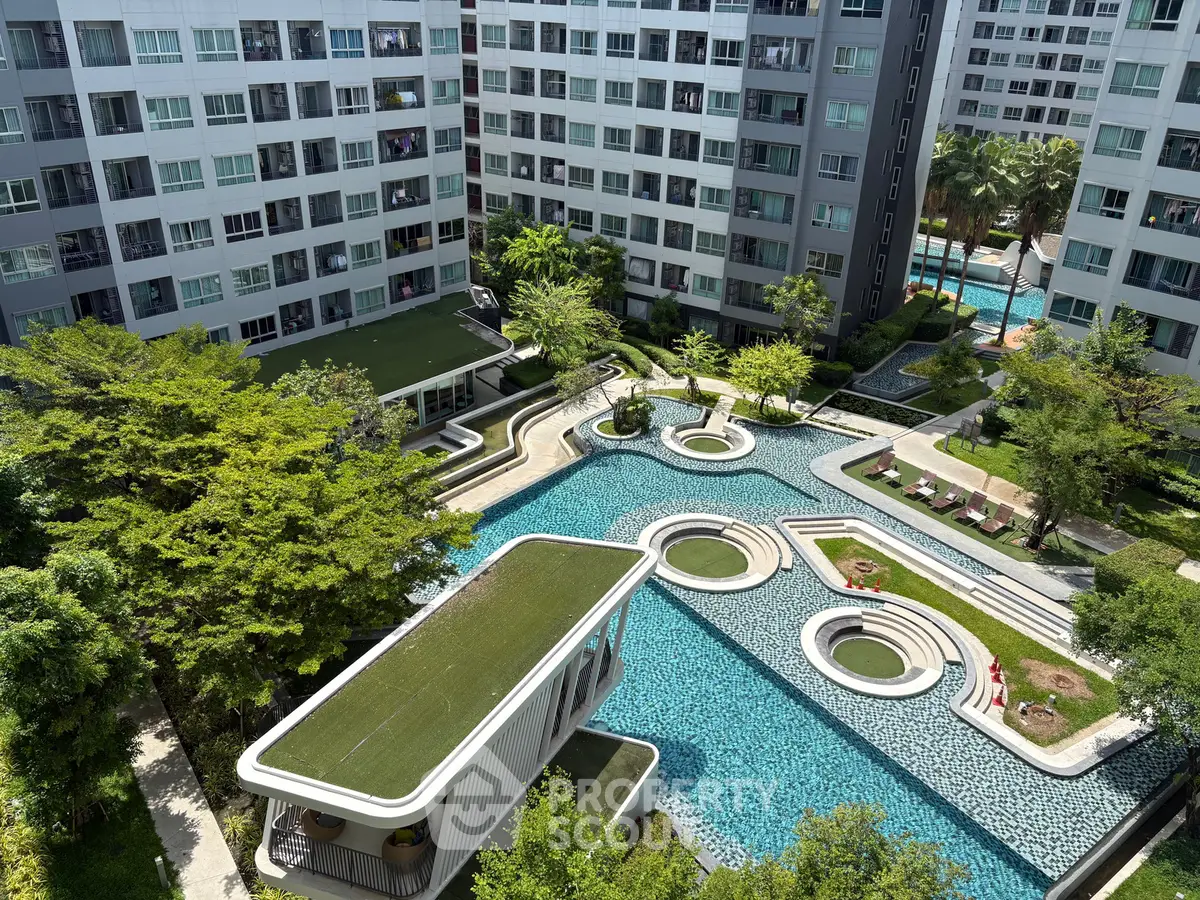 Modern apartment complex with stunning pool and lush greenery