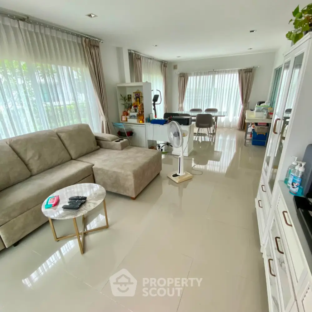 Spacious living room with modern furniture and large windows for natural light.
