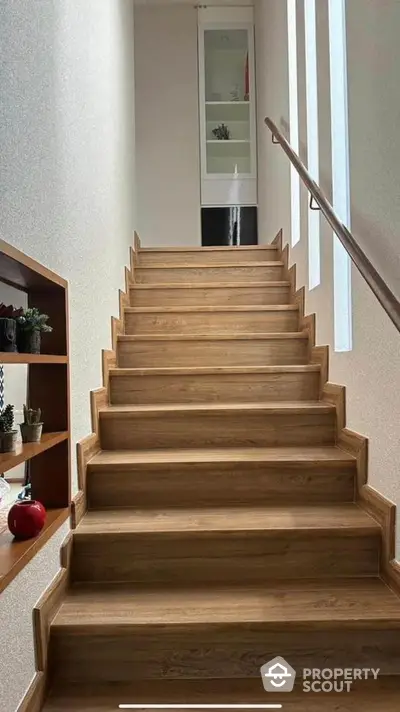 Modern wooden staircase with sleek design and natural light in contemporary home