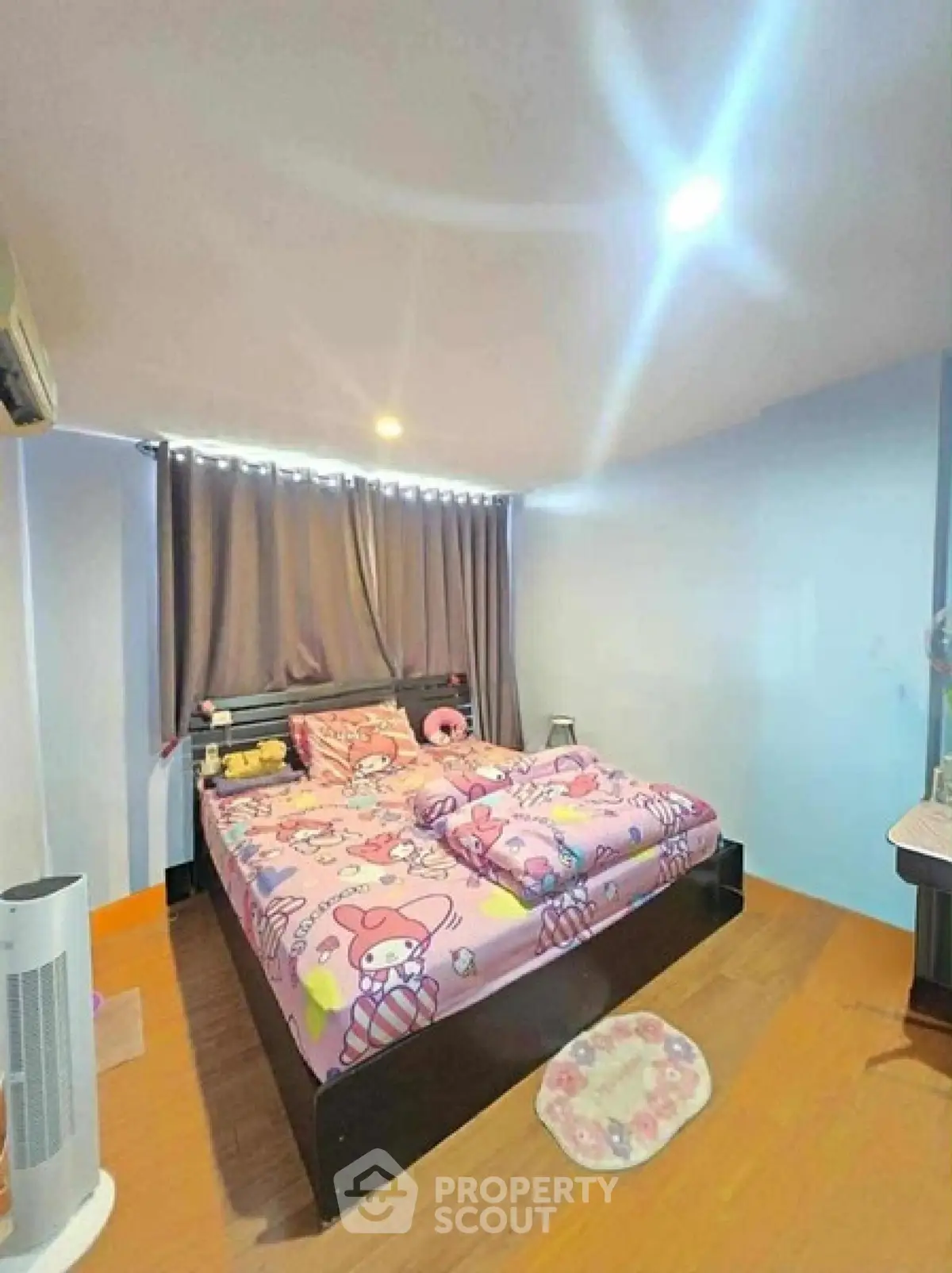 Cozy bedroom with colorful bedding and modern decor, perfect for a comfortable living experience.