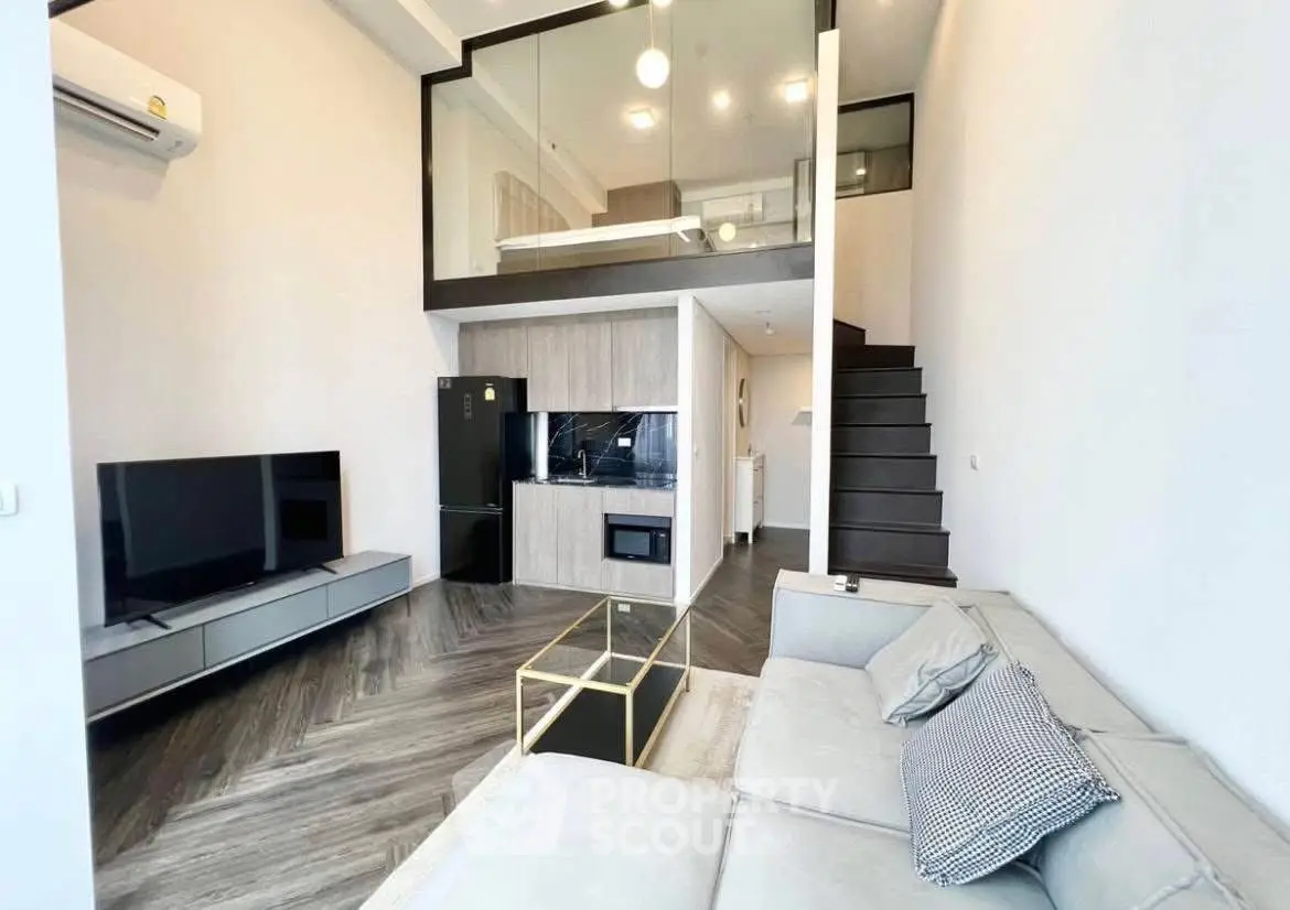 Modern loft-style living room with sleek design and mezzanine bedroom