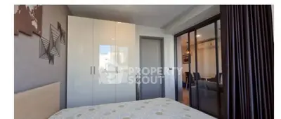 Modern bedroom with sleek wardrobe and stylish decor in a contemporary apartment.