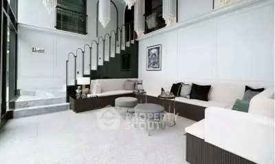Luxurious living room with elegant staircase and modern decor