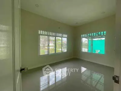 Spacious empty room with large windows and glossy floor, perfect for customization.