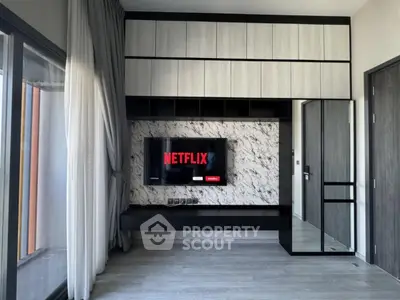 Modern living room with sleek TV setup and stylish cabinetry