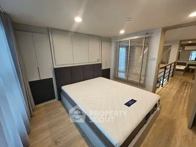 Spacious modern bedroom with elegant design and ample natural light