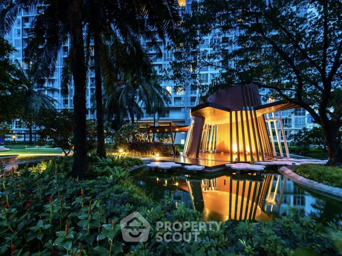 Luxurious garden view with modern architecture and serene water feature at dusk.