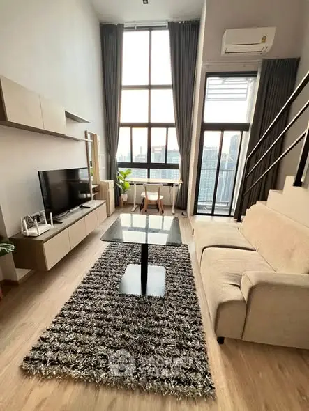 Modern loft living room with high ceilings and city view