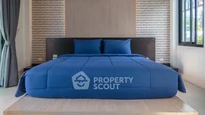 Modern bedroom with stylish decor and large window for natural light