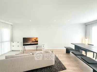 Spacious modern living room with sleek furniture and natural light