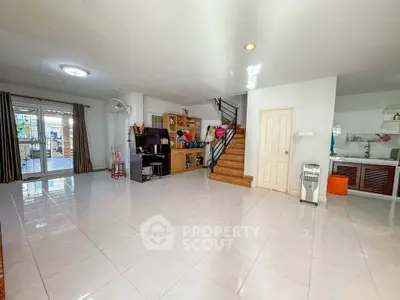 Spacious open-plan living area with modern staircase and ample natural light