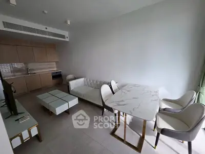 Modern open-plan living room with stylish furniture and sleek kitchen design