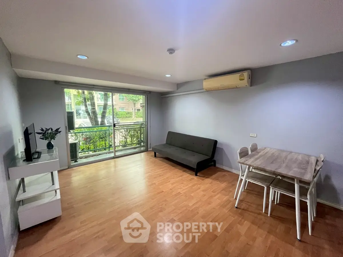 Spacious living room with modern decor and large window view