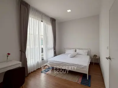 Modern minimalist bedroom with large window and stylish decor