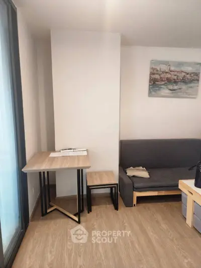 Cozy living room with modern furniture and wooden flooring, perfect for relaxation and comfort.