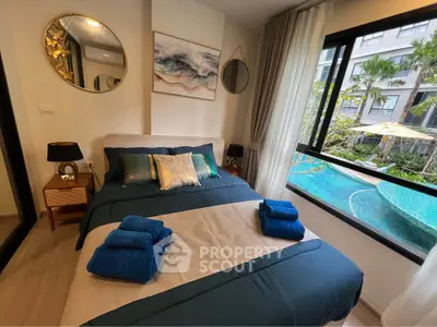 Luxurious bedroom with pool view, elegant decor, and modern furnishings in a prime real estate location.
