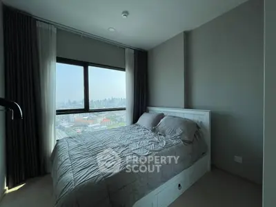 Modern bedroom with city view, featuring a cozy bed and large window.