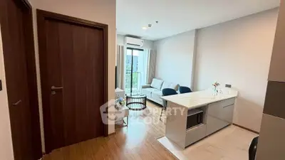 Modern open-layout living room with kitchen island and balcony view