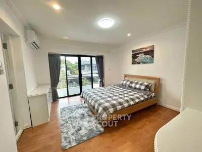 Spacious bedroom with balcony access and modern decor in a stylish apartment.